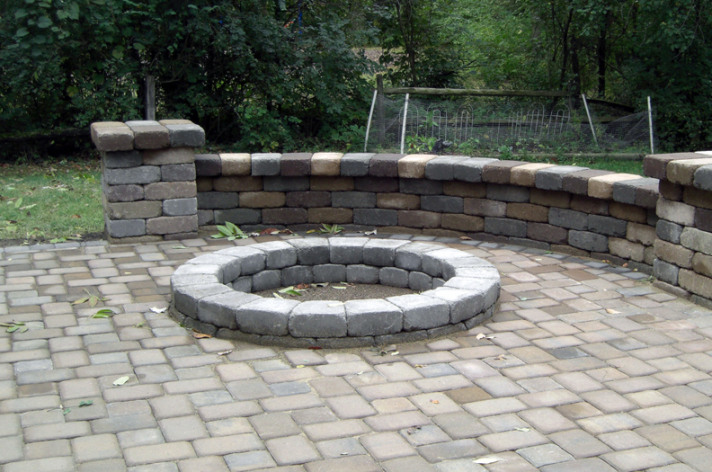 Suncraft Design Build custom fire pit with stone seating wall and room for furniture residential backyard Columbus Ohio
