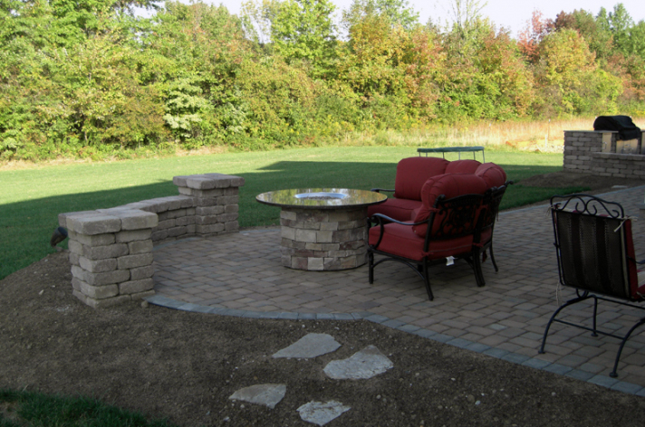 Suncraft Design Build custom outdoor fireplace with dining table and wood seating Columbus Ohio
