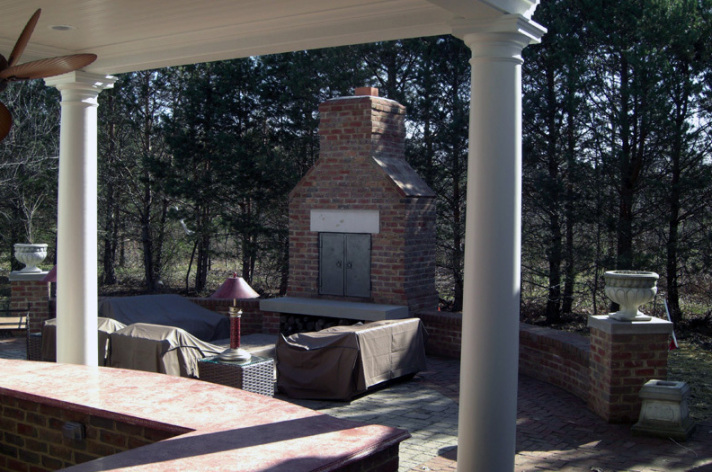 Suncraft Design Build custom outdoor fireplace with stone surround and dining area Columbus Ohio