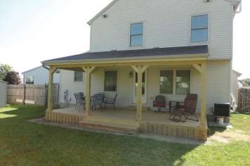 Suncraft Design Build custom open porch addition with white columns attached residential home Columbus Ohio