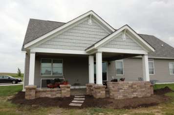 Suncraft Design Build custom open porch addition with columns and stone patio steps Columbus Ohio