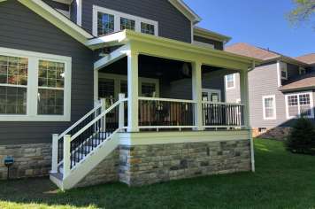 Suncraft Design Build custom open porch with white columns and railing two-story home Columbus Ohio