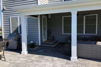 Suncraft Design Build custom open porch with white columns attached gray siding home Columbus Ohio