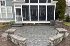 Suncraft Design Build custom paver patio with sunroom and stone seating wall Columbus Ohio