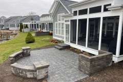 Suncraft Design Build custom paver patio with stone seating wall and sunroom Columbus Ohio