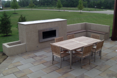 Suncraft Design Build custom paver patio with built-in outdoor fireplace and dining table Columbus Ohio