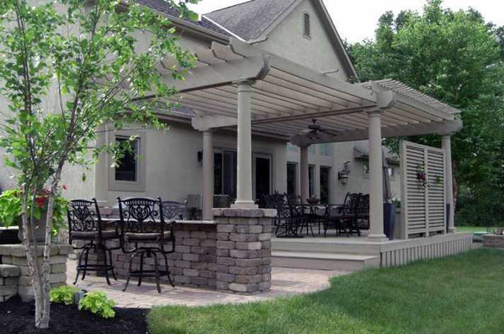 Suncraft Design Build custom pergola with white columns and stone home Columbus Ohio