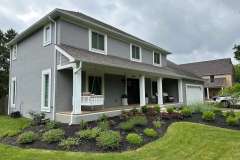 Suncraft Design Build custom front porch addition with white columns two-story gray residential home Columbus Ohio