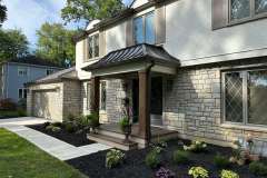 Suncraft Design Build custom portico with stone and timber columns dark door residential home Columbus Ohio
