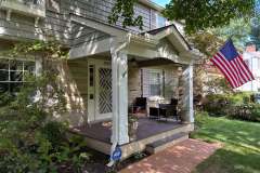 Suncraft Design Build custom front porch addition with white columns American flag brick steps Columbus Ohio