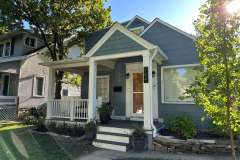 Suncraft Design Build custom open portico addition with white columns attached gray residential home Columbus Ohio