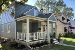 Suncraft Design Build custom front porch with white columns and railings two-story home Columbus Ohio