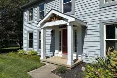 Suncraft Design Build custom front porch with white columns and red door residential home Columbus Ohio