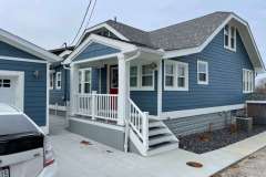 Suncraft Design Build custom small front porch addition with white columns and railings blue residential home Columbus Ohio
