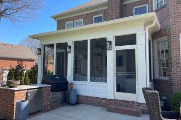 Screened porch on brick home Columbus Ohio custom home addition stairs